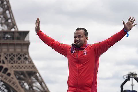2012 London Olympics men's 85kg Weightlifting: Egypt's Tarek Yehia Fouad Abdelazim bites his bronze medal